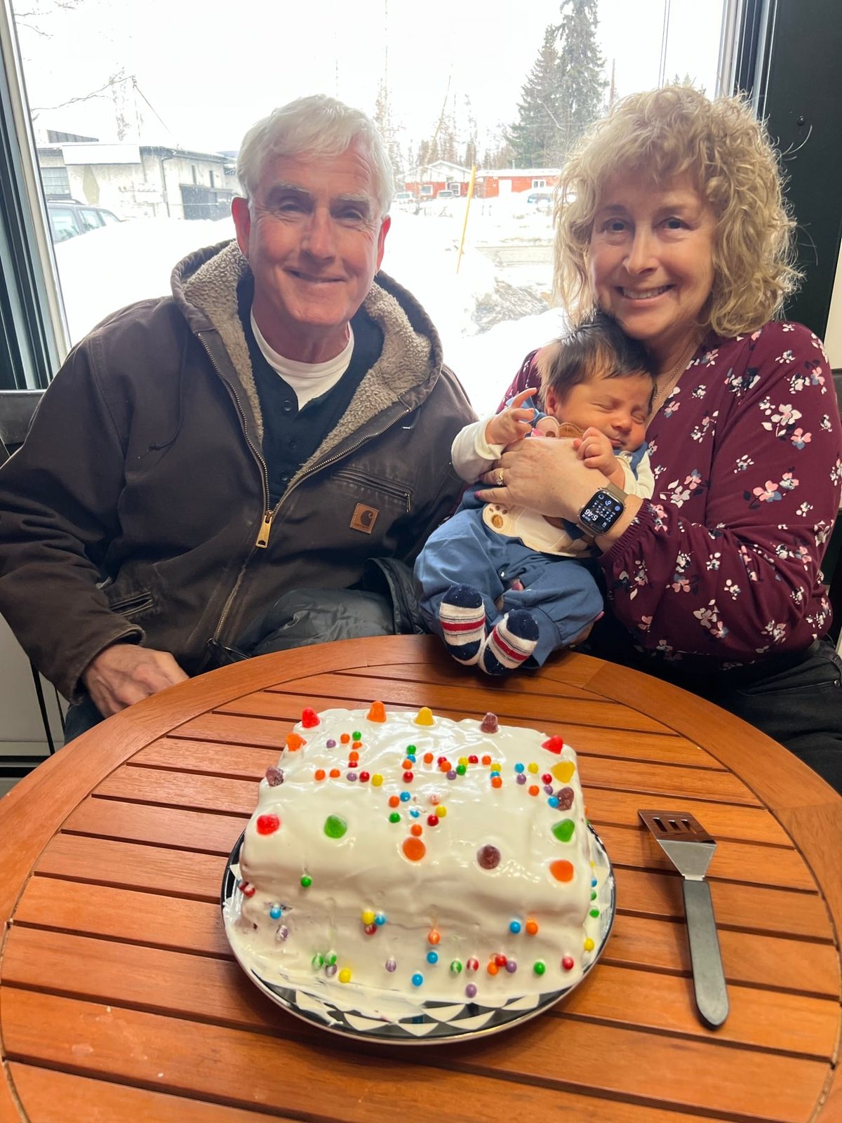 Karen and Bob celebrating with Charlie and a homemade cake