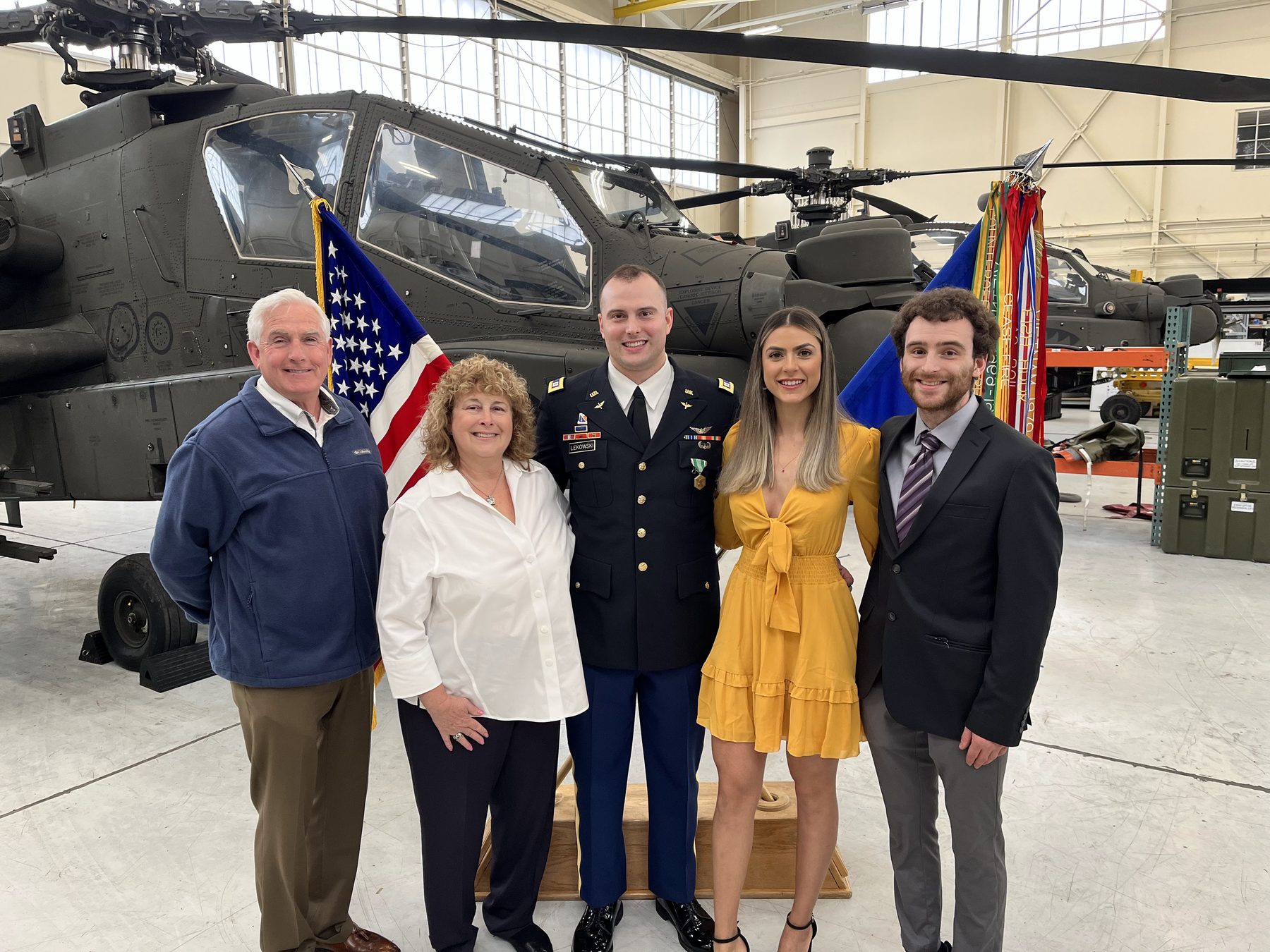 Bob, Karen, Andrew, Vivian and Joseph in front of an Apache helicopter