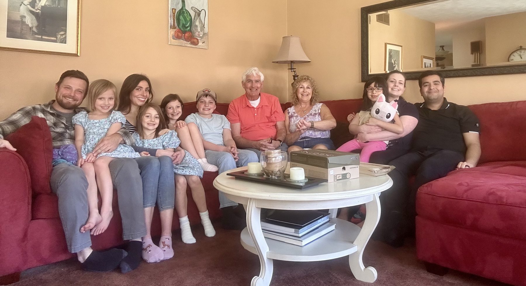 Karen and Bob surrounded by children and grandchildren